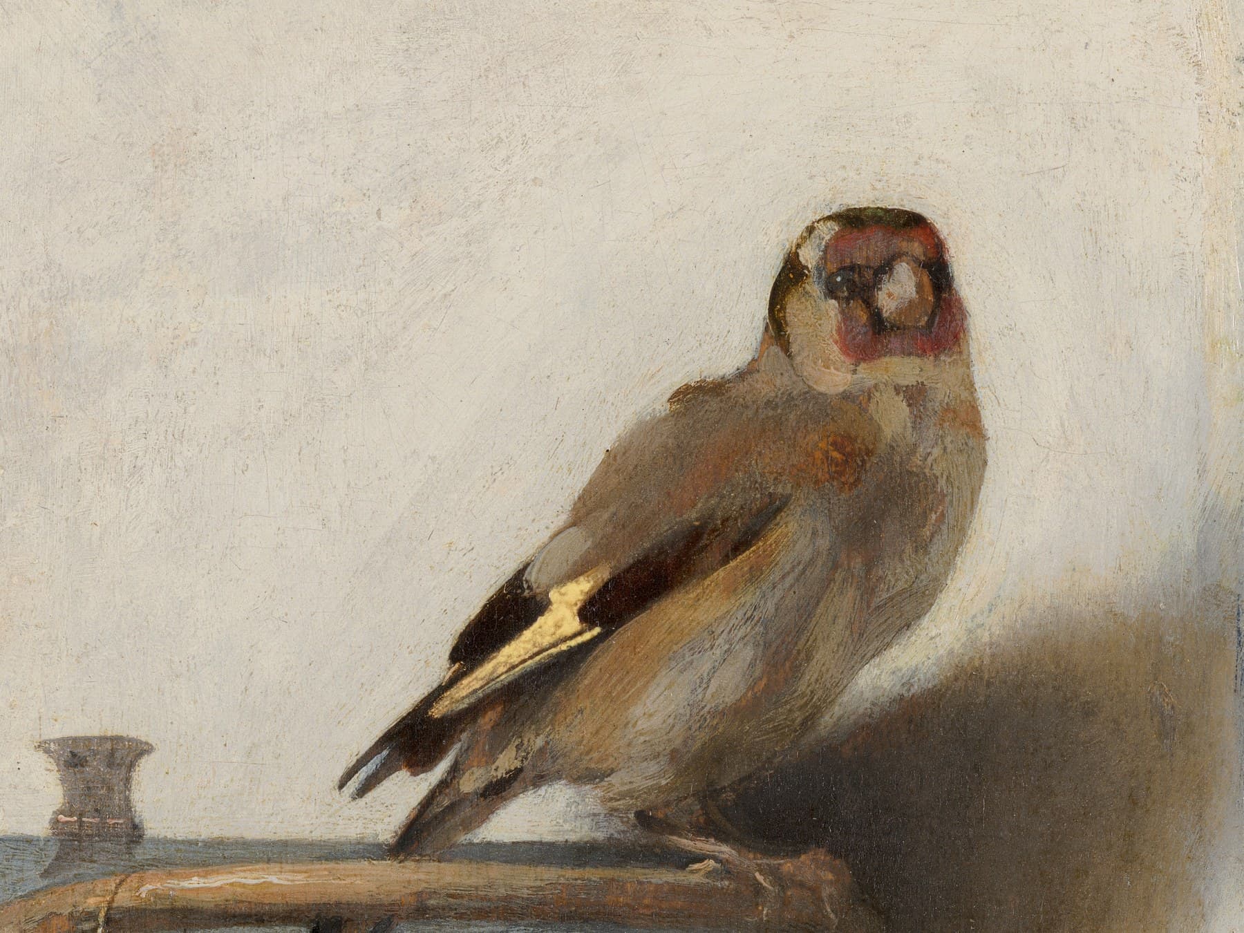 Carel Fabritius, The Goldfinch, 1654 (detail): a pet goldfinch on its feeding box